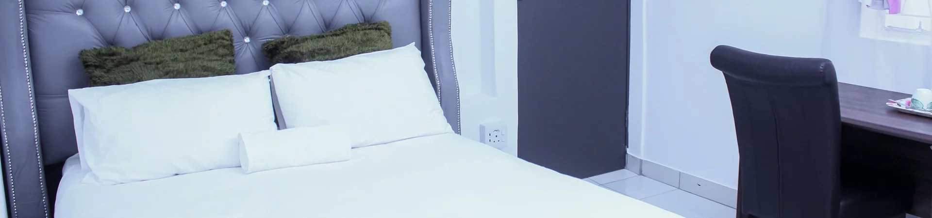 A cozy bed adorned with pristine white sheets and soft pillows, exuding a sense of comfort and tranquility.